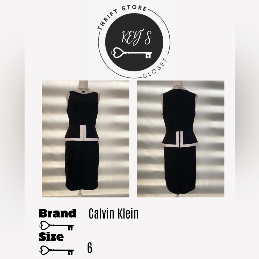 Sleeveless bussiness casual black dress with white details.